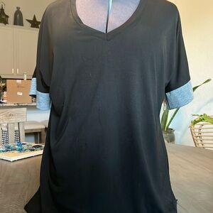 Black with grey sleeve bands. really cute. Marked as 3X but fits like a 1X.